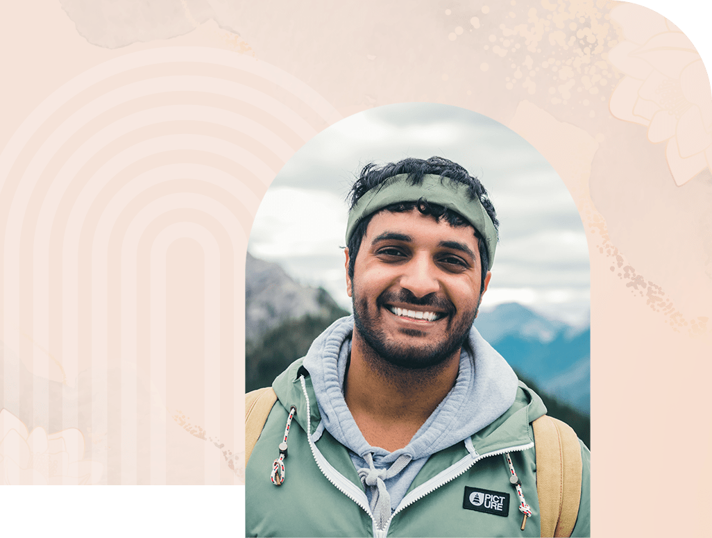 man smiling at camera outdoors