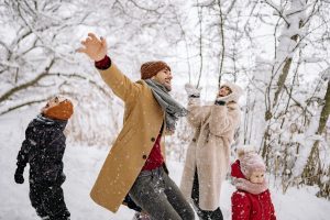 "Couple laughing, embracing joyful and imperfect holiday moments."