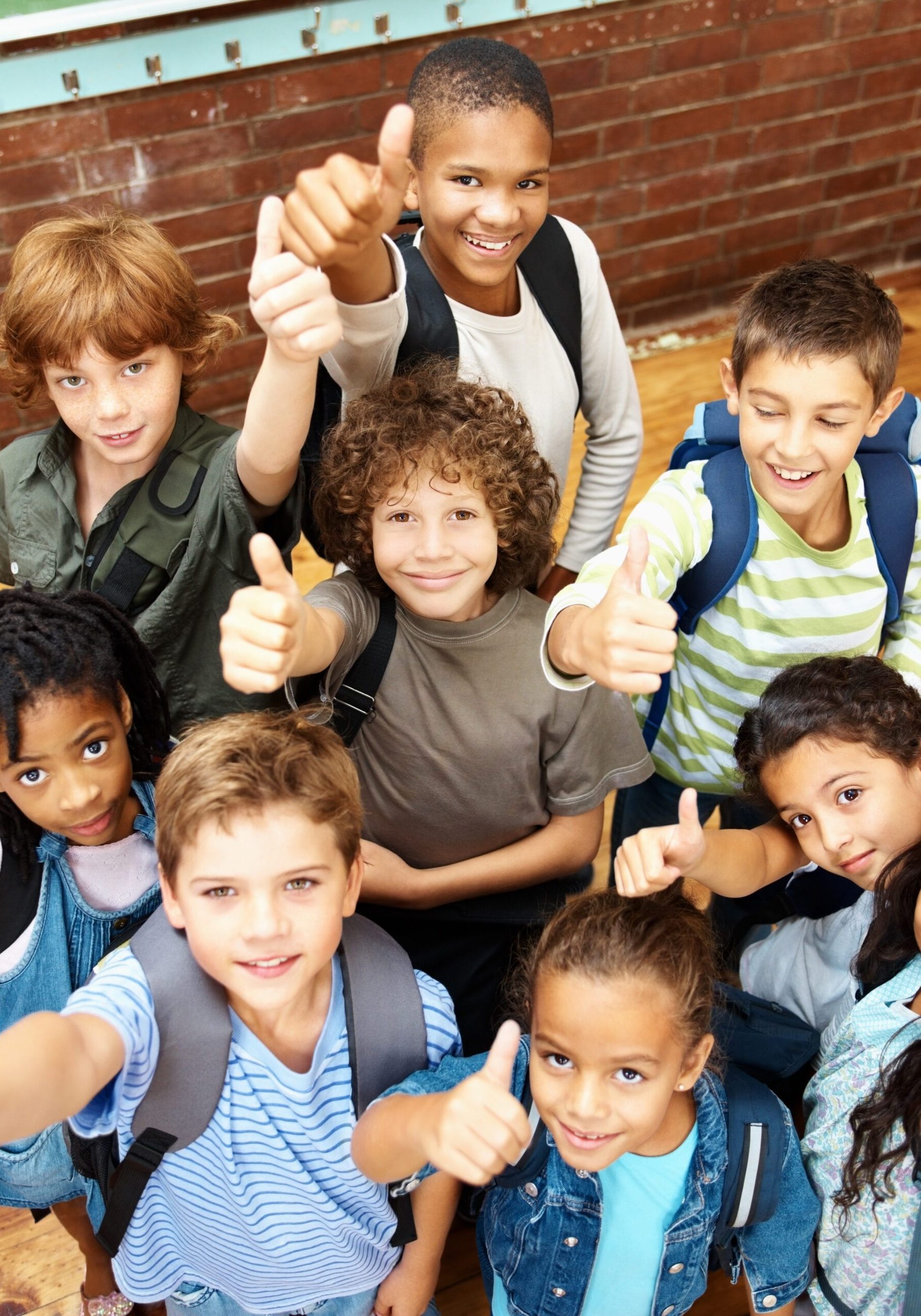 Top view of a group of elementary students showing a thumbs up sign