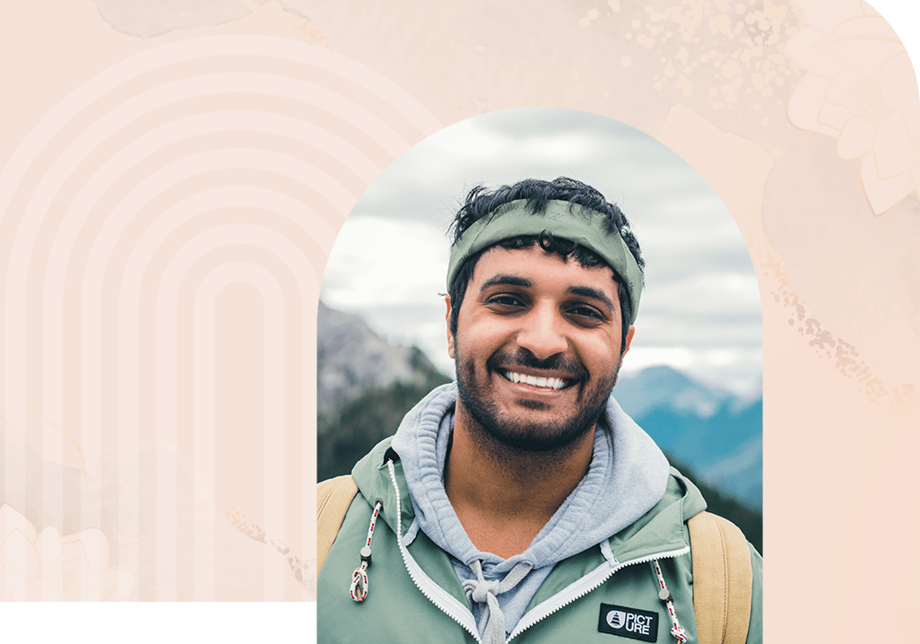 man smiling at camera outdoors